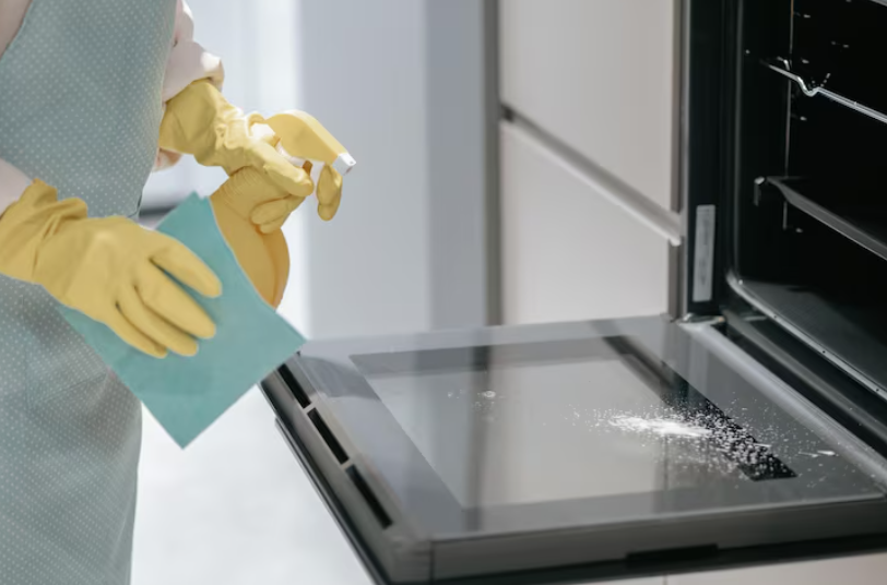 Service person cleaning the kitchen appliances