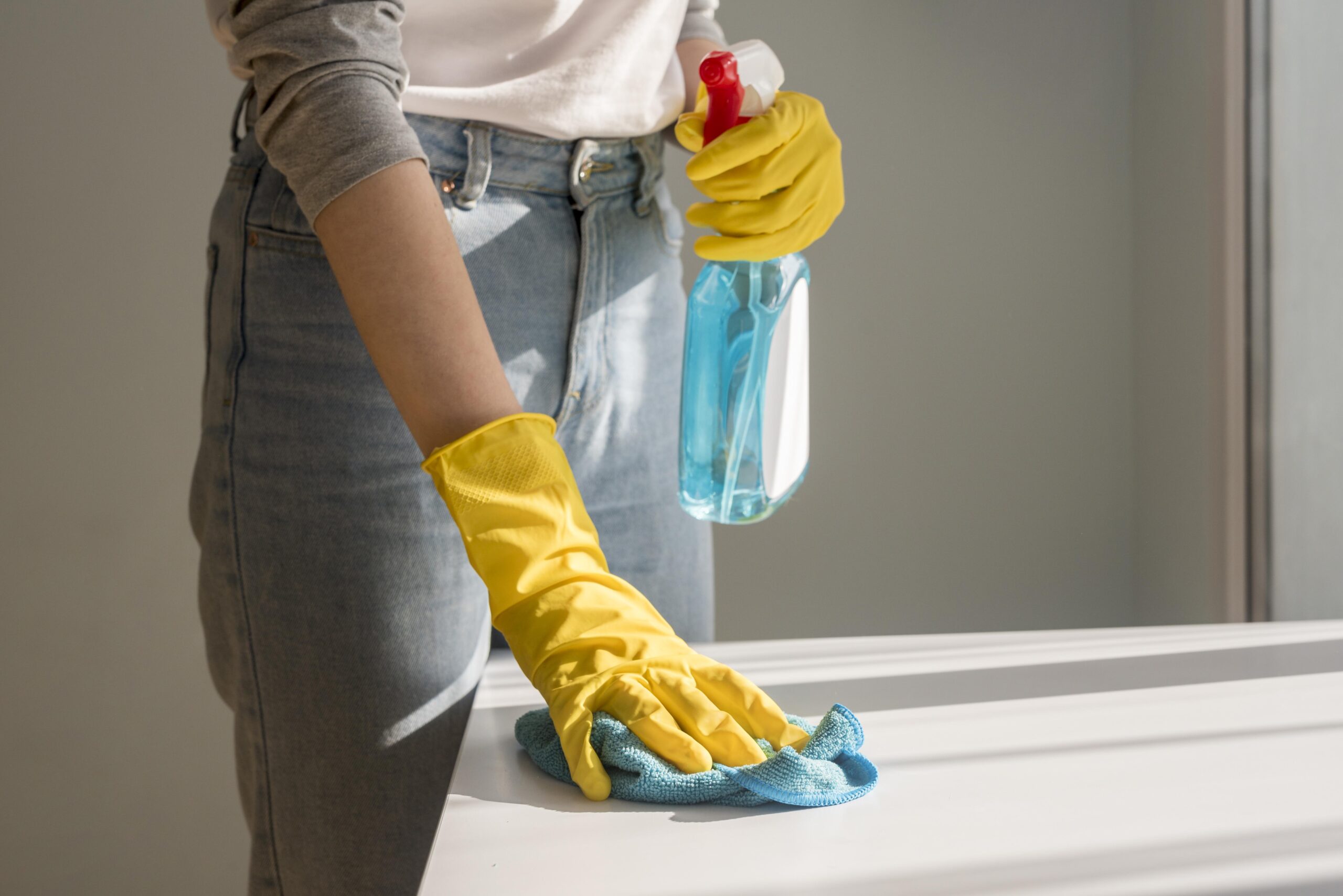 Front view of woman cleaning surface