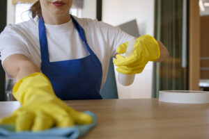 Professional cleaning service person cleaning office table